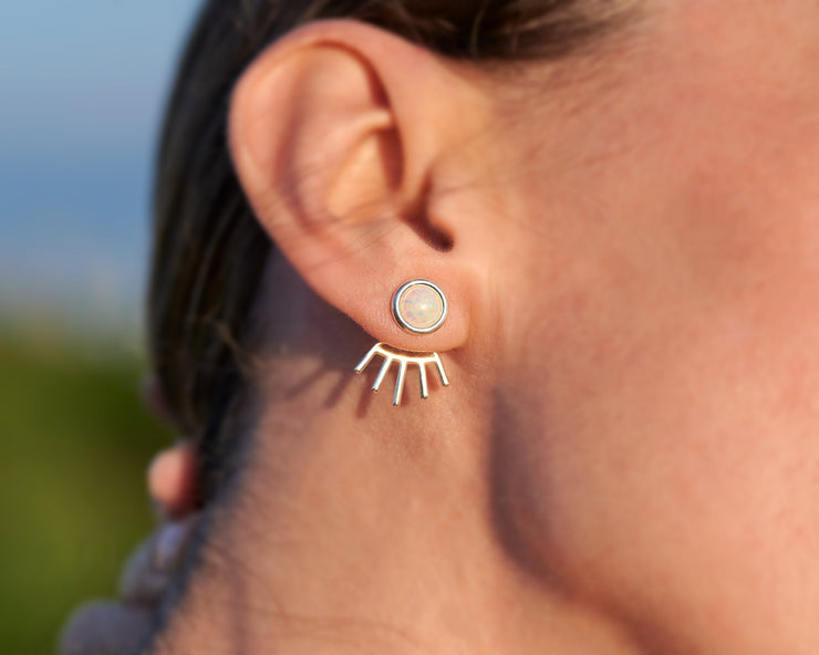 close up of woman wearing silver opal ear jacket stud earrings