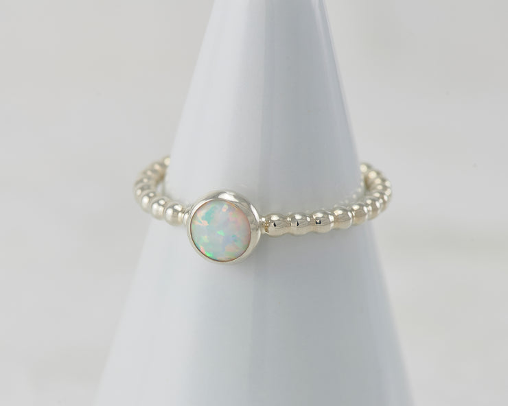 White ring holder with opal Silver ring