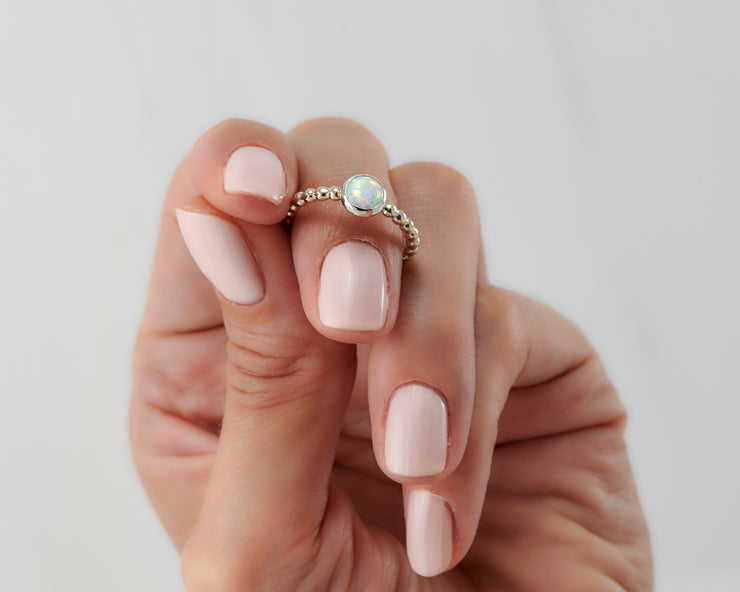 Woman holding opal silver ring