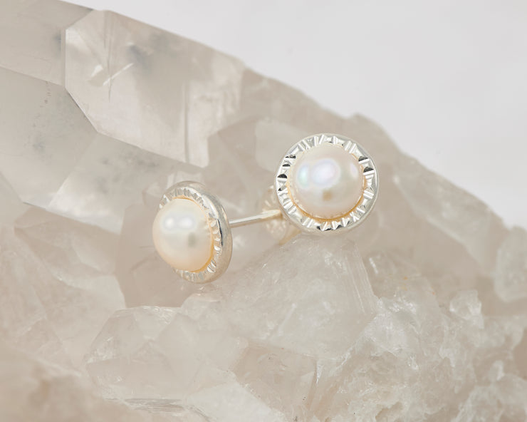 silver pearl stud earrings on crystal