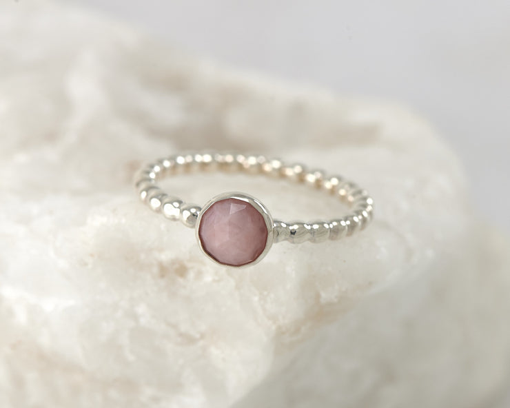 Silver peruvian pink opal beaded ring on white rock