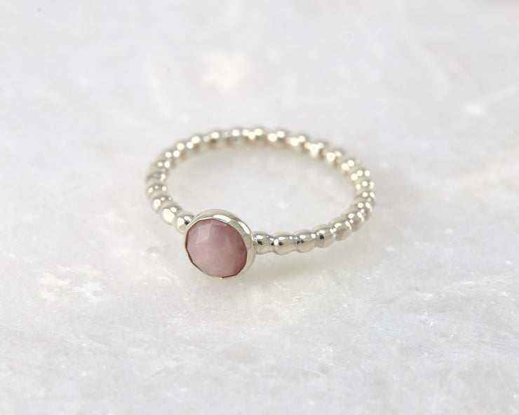 beaded peruvian pink opal ring on white marble