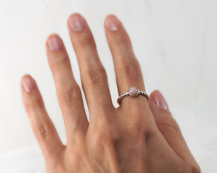 Woman wearing beaded peruvian pink opal ring