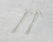 silver bar earrings on white marble