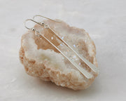 silver bar earrings on quartz