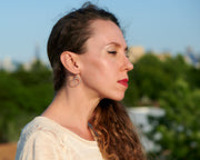 Woman wearing silver hoop beaded circle hoop earrings