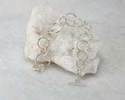Silver chain link Bracelet on white rock