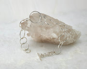 chain link latch bracelet shown open on crystal rock