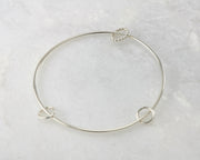 bangle style charms silver bracelet on marble