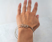 woman wearing silver charms bangle bracelet