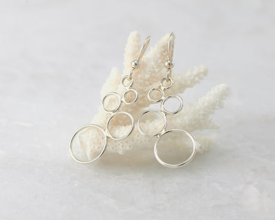 Silver circles chandelier earrings on coral