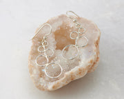 Silver circles chandelier earrings on quartz