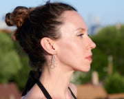 Woman wearing silver circles chandelier earrings