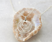 silver circles necklace on quartz