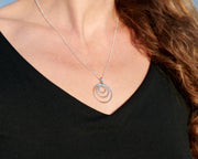 Close-up of woman wearing silver circles necklace