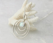 Silver opal circles necklace on coral