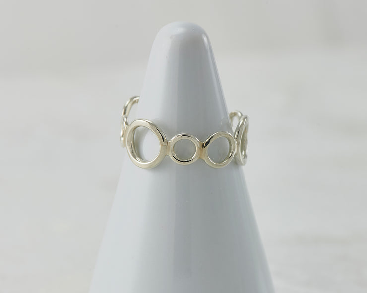 Silver circles ring on white ring holder