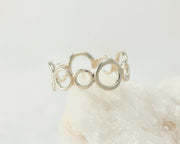 Silver circles statement ring on white rock