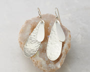 Silver teardrops earrings on crystal rock