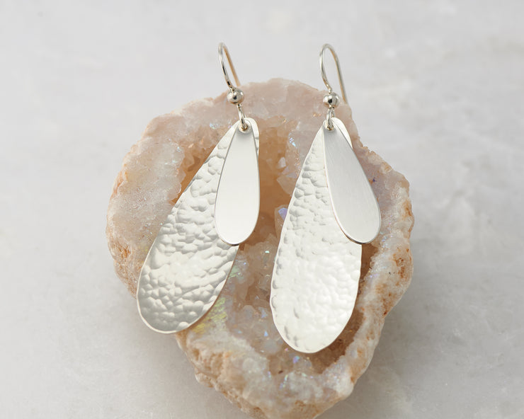 Silver teardrops earrings on crystal rock