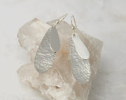 Silver teardrops earrings on crystal rock
