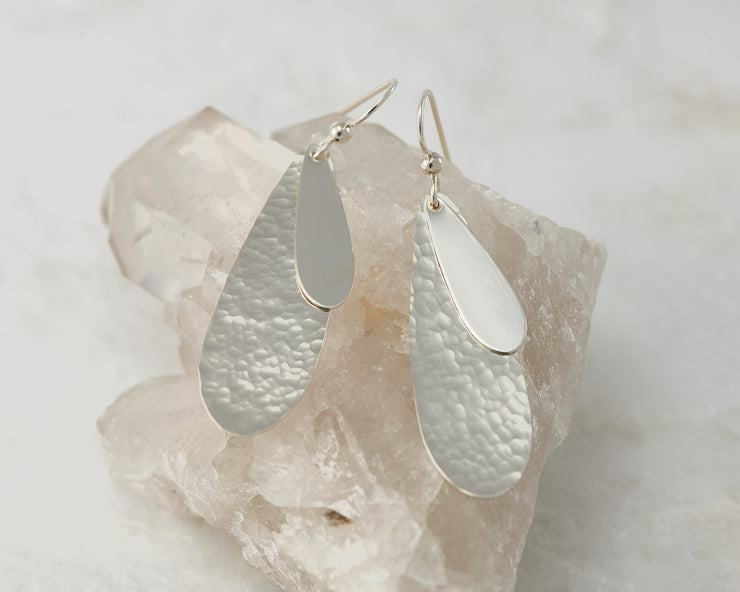 Silver teardrops earrings on crystal rock