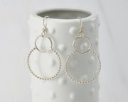 Silver polished beaded circles hoop earrings on dotted vase