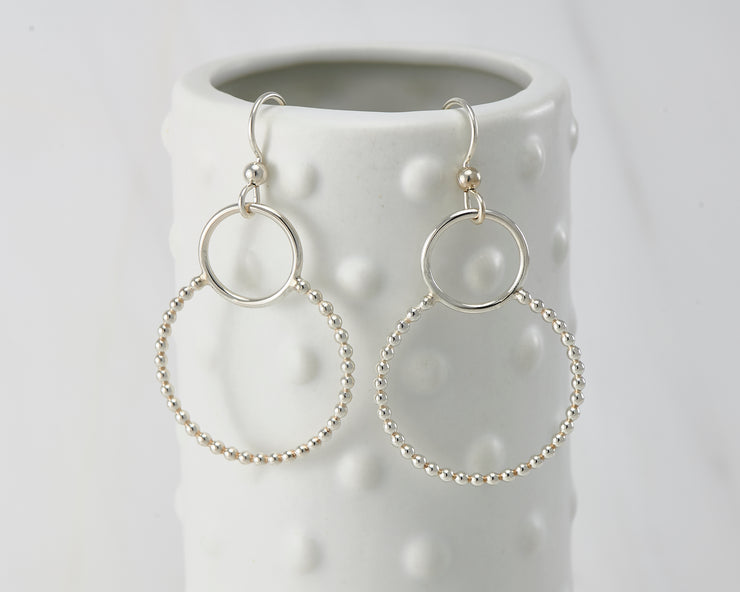 Silver polished beaded circles hoop earrings on dotted vase