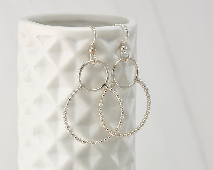 Silver beaded circles hoop earrings on geometric vase