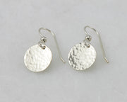 Silver Hammered earrings on white marble