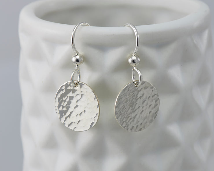 Disc Dangle Earrings on geometric vase