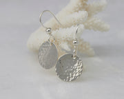 Sterling Silver earrings hanging from coral