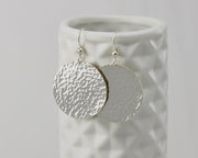 Disc Dangle Earrings on geometric vase