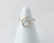 White ring holder with Geometric Silver ring