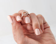 Woman holding geometric silver ring
