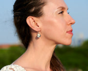 woman wearing silver and gold disc earrings