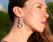 Silver earrings being worn by a woman