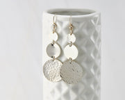 Disc Dangle Earrings on geometric vase