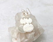 Hammered Dangle Earrings shown on a crystal rock