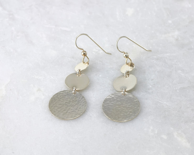 Silver Hammered earrings on white marble