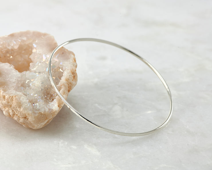 hammered latch bangle bracelet shown on crystal rock