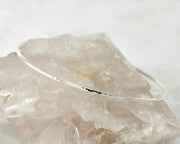 hammered latch bangle bracelet shown on crystal rock
