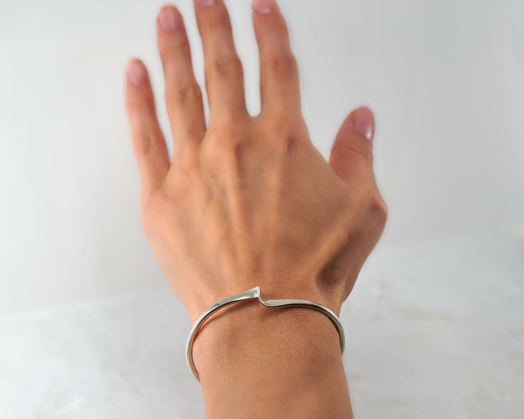 Woman wearing silver wave cuff bracelet