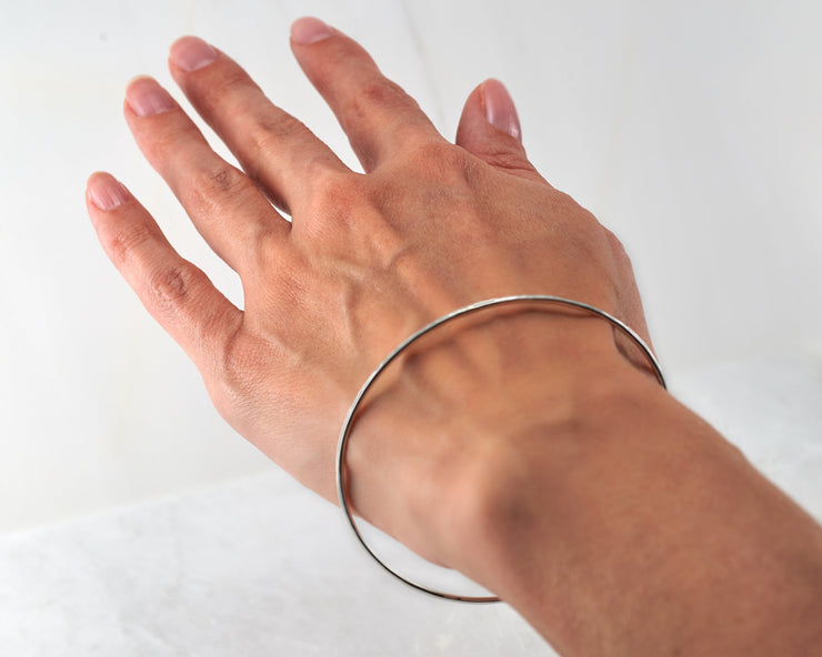 Woman wearing silver hammered bangle bracelet