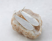 silver hammered teardrop earrings on quartz