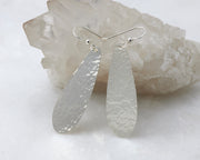 silver thread earrings on white crystal