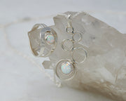 Silver opal ring and silver opal necklace on crystal