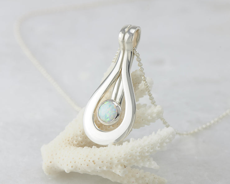 Silver opal pendant on coral