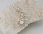 Silver opal necklace on crystal rock