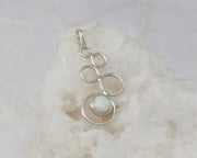 Silver opal pendant on white rock